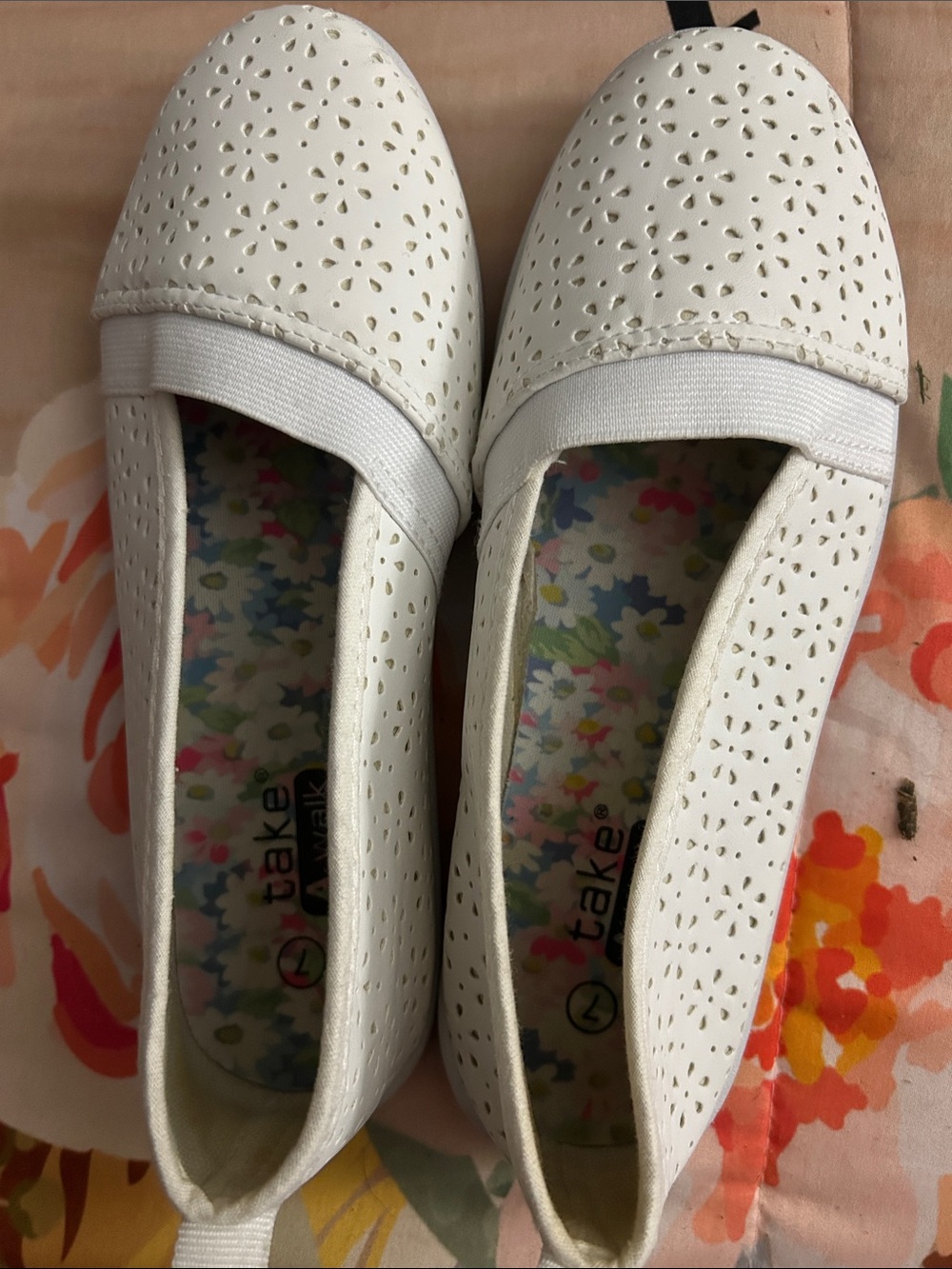 Woman’s White Floral-Trim Slip-On Flats